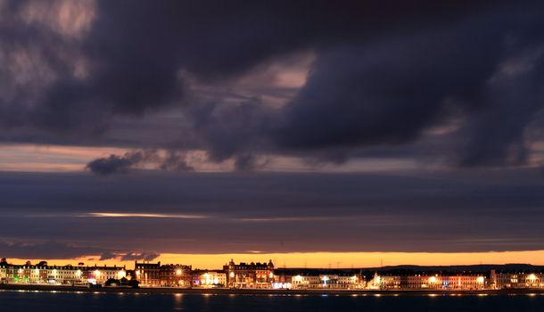 Night sets in  over Weymouth seafront taken from view over the sea