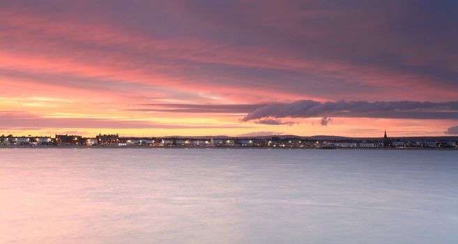 The sunsets over Weymouth seafront taken from view over the sea