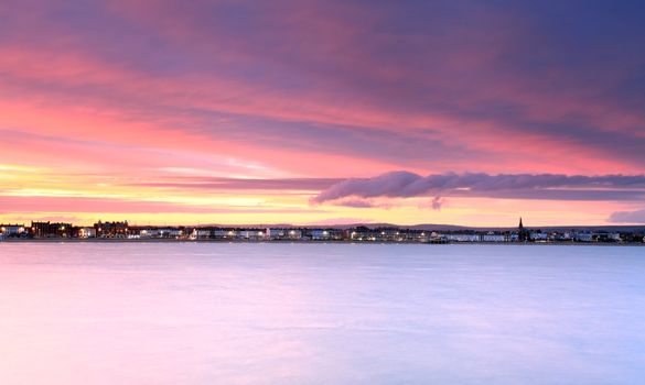The sunsets over Weymouth seafront taken from view over the sea