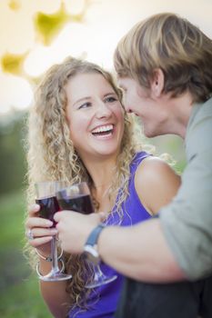 An Attractive Couple Enjoying A Glass Of Wine in the Park Together.