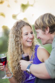 An Attractive Couple Enjoying A Glass Of Wine in the Park Together.