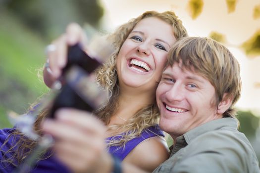 An Attractive Couple Enjoying A Glass Of Wine in the Park Together.