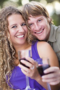 An Attractive Couple Enjoying A Glass Of Wine in the Park Together.