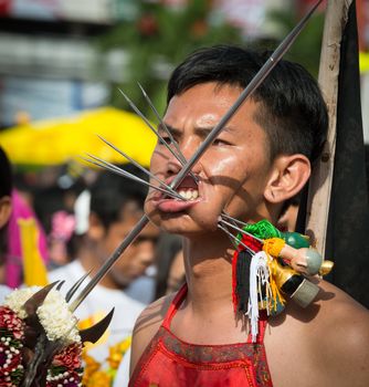 Phuket, Thailand - October 21, 2012: Devotee of Vegetarian Festival is Mah song, person who invites the spirits of gods to possess their bodies.  Mah song wearing elaborate costumes and pierce their cheeks and tongues with all manner of things.