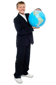 Smart looking young kid holding globe with both hands. Covering top and bottom