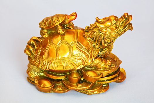 studio shot of ornamental feng shui mother tortoise and offspring on her back, rendered photograph