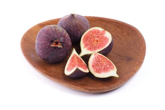 Perfect Figs Full Body and Slices on Wood Plate isolated on white background