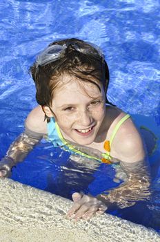 girl smiling and happy in the pool in summer