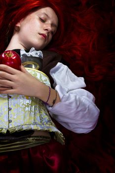 Young woman with red apple in a poetic representation