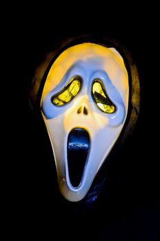 Halloween ghost mask shot against black background