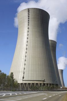 photograph of a chimney of a nuclear power plant in activity