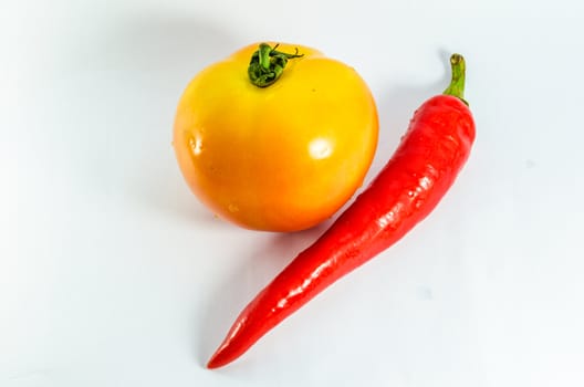 Tomato and chili isolated on white