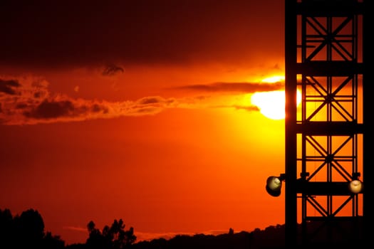 An orange and red sunset in an urban setting.