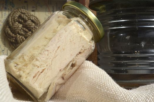tuna canned in glass jar and maritime motifs