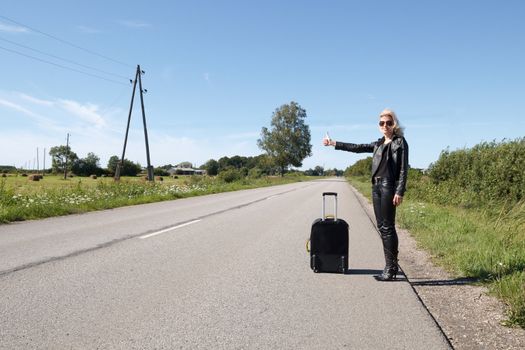 lonely hitchhiker at rural roadside