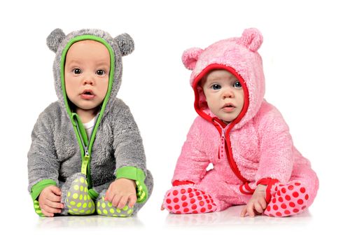 Six month old twin brother and sister on white background