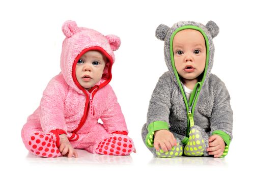 Six month old twin brother and sister on white background