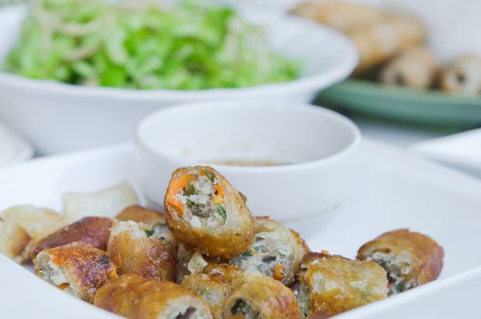 Chinese spring rolls on plate served with sweet sauce