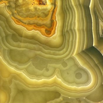 Magnified image details of a layer of onyx, green, yellow and orange
