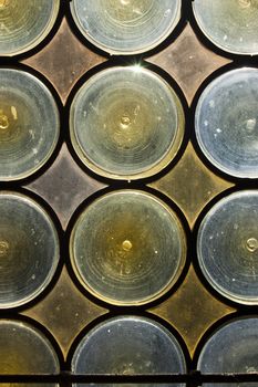Old window with stained glass - opaque blue and yellow circles
