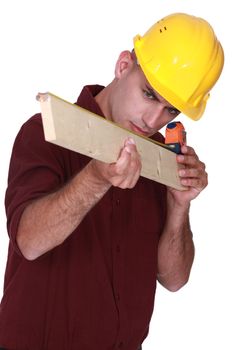 Carpenter measuring a piece of wood