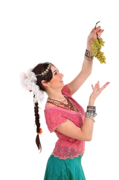 Young girl in the Indian national dress with grapes
