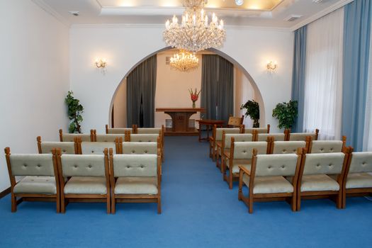 small rural wedding ceremony room with chandelier