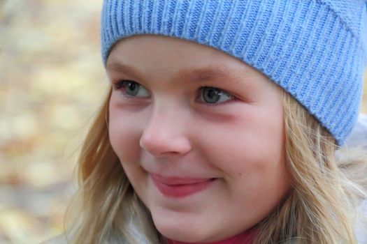 Portrait of beautiful girl with blond hair and blue eyes