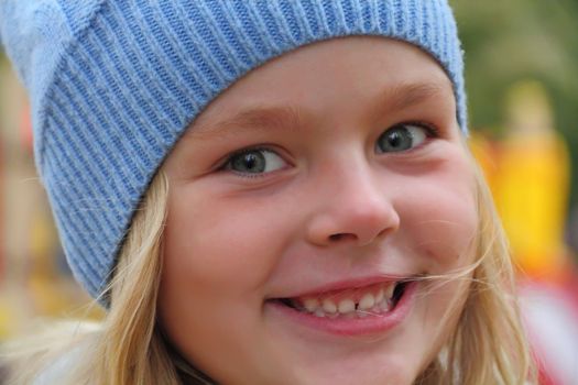 Portrait of beautiful girl with blond hair and blue eyes