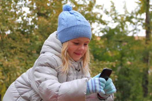 Portrait of small girl with cellular phone