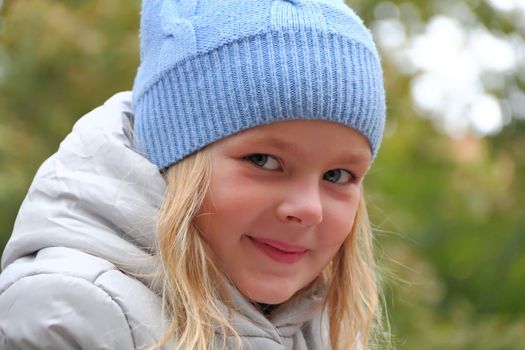 Portrait of beautiful girl with blond hair and blue eyes