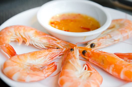 Boiled shrimps on plate served with spicy sauce