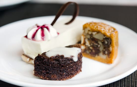 Chocolate cake and  sweet dessert on white dish