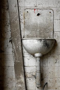 Old basin in an abandoned, ruined building