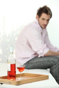 depressed man looking a wine bottle