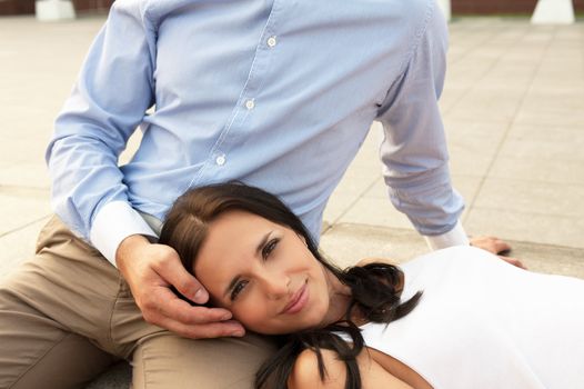 woman lying at mans knees at outdoor