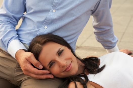 woman lying at mans knees at outdoor