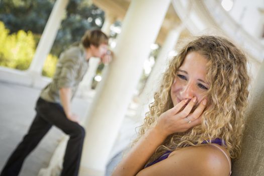 Woman Upset in the Foreground While Man Comtemplates in the Background