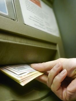 Finger using automatic teller keypad to enter pin number