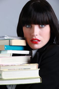 Beautiful woman with a stack of books