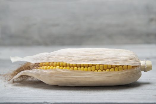 Dried corn ear on an old wooden background