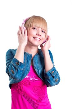 Young attractive woman listing to music with headphones against white background