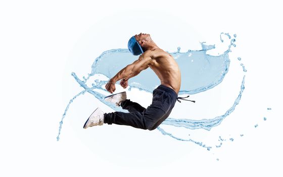 Dancer jumping on the background color splashes