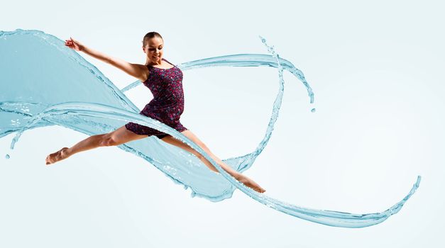 Dancer jumping on the background color splashes