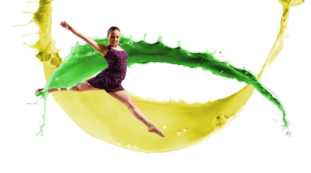 Dancer jumping on the background color paint splashes