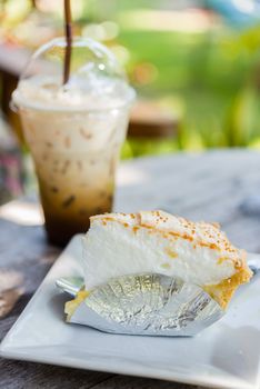 coconut cake on table with ice coffee in afternoon time