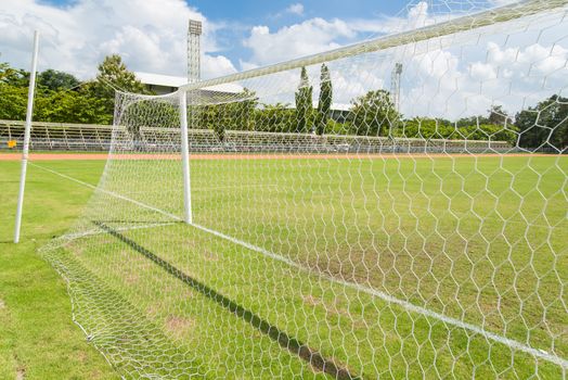 Soccer goal net in football field grass in stadium