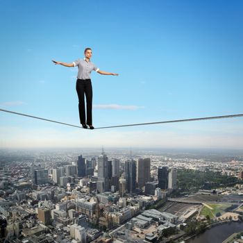 Business woman balancing high over a cityscape