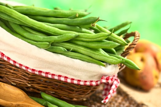 Fresh raw green beans in basket (Selective Focus, Focus on the beans in the front in the basket)