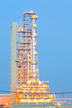 Distillation tower at Oil Refinery Plant at dusk
